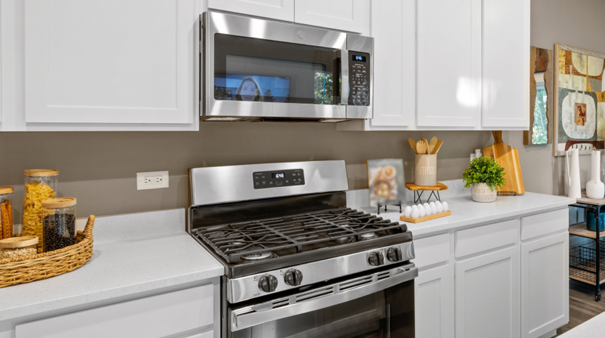 Darcy GE stainless steel kitchen appliance package includes a built-in microwave and 4-burner gas range