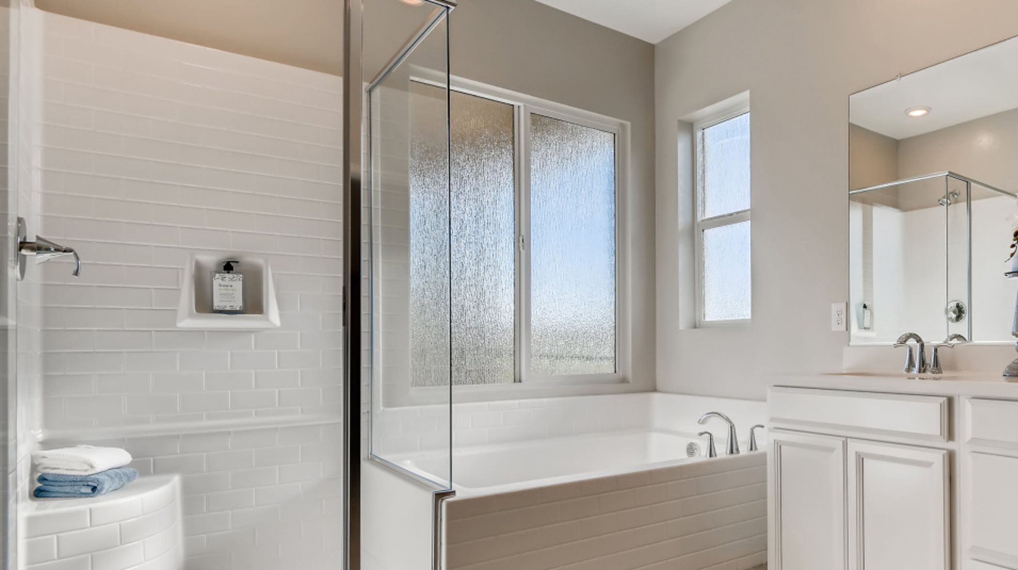 Separate shower and soaking tub in the bathroom of the owner’s suite