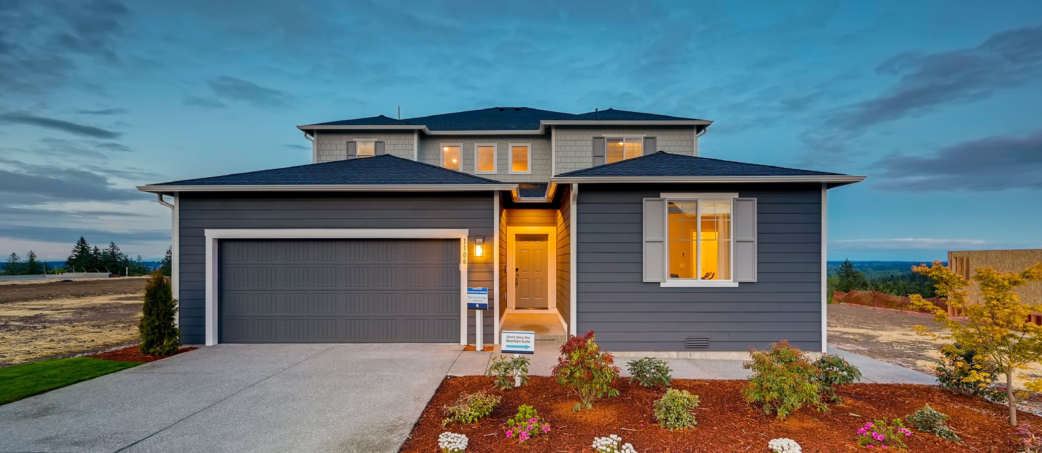 Beautiful new home in a grey color scheme captured at twilight 
